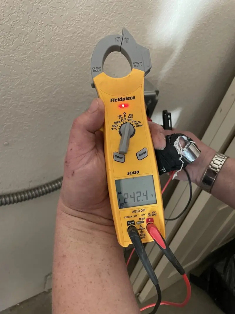 Voltage testing with clamp meter during Whole House Surge Protector in North Hills